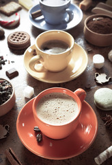 cup of coffee, tea and cacao at abstract background