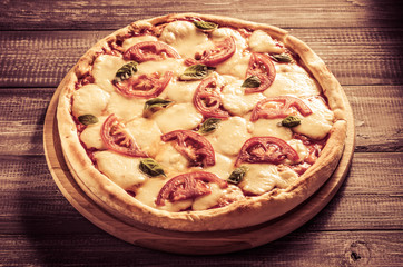 margarita pizza at wooden table