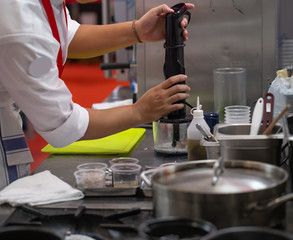 Chef blending meat in hand stick blender. Homemade cooking food