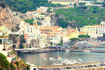Fototapeta na wymiar Panoramic scenic view of Amalfi Coast, Campania, Italy, in summer with traditional Italian architecture on mountains, beautiful blue sea and luxury yachts