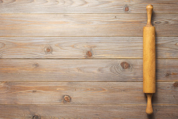 rolling pin at wooden board