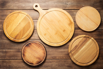 pizza cutting board at wooden plank table