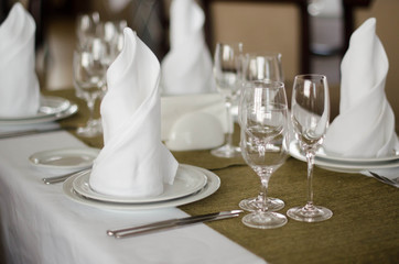 Shot of napkins and wine glasses banquet table at luxury restaurant
