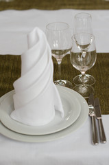 Shot of napkins and wine glasses banquet table at luxury restaurant