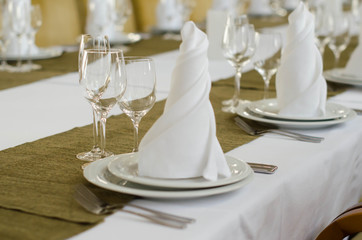 Shot of napkins and wine glasses banquet table at luxury restaurant