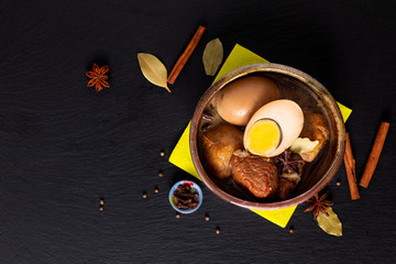 Food concept Thai cuisine Pork Belly and Egg with five spice Fragrant Stew Moo Palo on black slate board with copy space