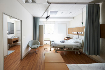 Fototapeta na wymiar Beds In Empty Hospital Ward