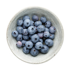Fresh ripe blueberry berries in bowl isolated on white background. Top view. Flat lay.
