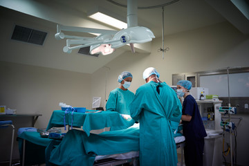 Surgical Team Working On Patient In Hospital Operating Theatre