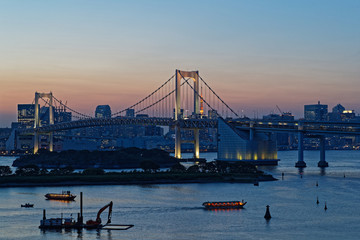 TOKYO, JAPAN, May 17, 2019 : Night on Rainbow Bridge in Odaiba. The Greater Tokyo Area is ranked as the most populous metropolitan area in the world.