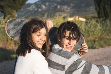 Portrait of a couple with happy and fun skateboarders