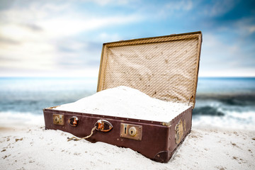 Summer suitcase on beach and sea landscape 