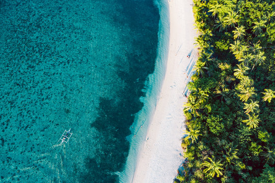 Top down view of tropical landscape with turquoise water and white sand
