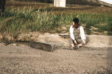 Portrait of a young girl with hat and skateboard