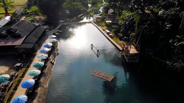 famous blue lagoon in the hot day, Vangvieng. Laos, Clear clear water in the lagoon. quadcopter, flying, movement, motion, 4K move drone