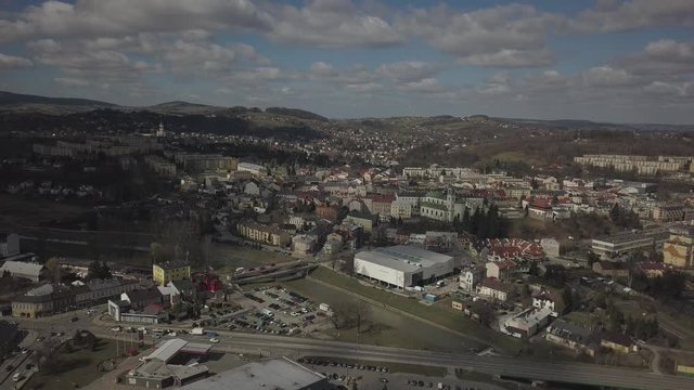 Gorlice, Poland - 4 5 2019: Panorama of the historic center of the European medieval city on the picturesque green hills. Trips to architectural monuments, temples, quarters and sports complex MOSiR