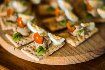 Sandwiches with liver pate and egg on wooden background.