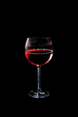Cup of red drink with black background