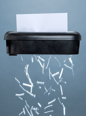 A shredder destroying a document