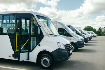 number of new white minibuses and vans outside. - obrazy, fototapety, plakaty