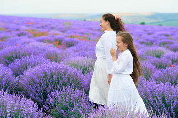 girls are in the lavender flower field, beautiful summer landscape