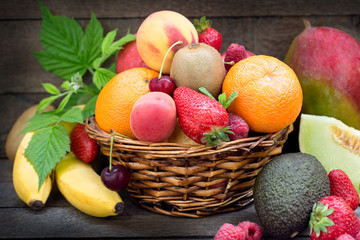 Healthy food, different organic fruits, fresh fruit in wicker basket