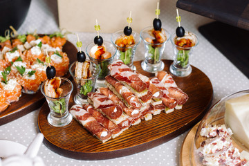 Shrimp canape, salmon with cheese. Rolls of jamon.