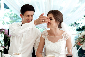 stylish gorgeous happy bride and groom having fun at wedding reception, emotional cheerful moment