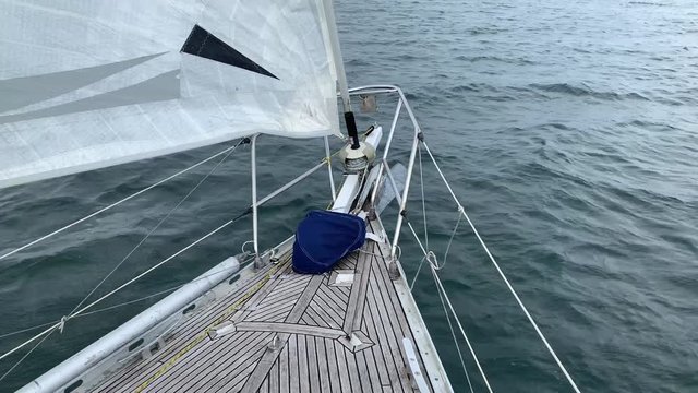 bow of a sailing yacht dissecting the surface of the sea