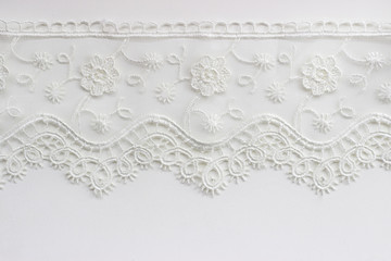 White lace on white background; fabrics sample