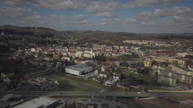 Gorlice, Poland - 4 5 2019: Panorama of the historic center of the European medieval city on the picturesque green hills. Trips to architectural monuments, temples, quarters and sports complex MOSiR