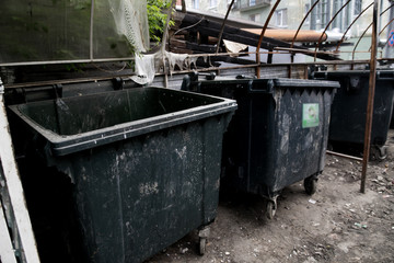 Dirty trash containers messy dirt everywhere