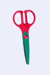 Colorful plastic scissors, top view. Colored open scissors isolated on white background.