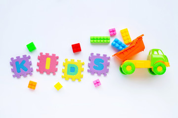 Colorful Kids toys with alphabet "KIDS" Puzzle Pieces  on white.