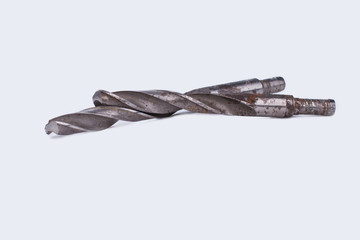 Rusty drill bits on white background. Old spiral tool for perforator. Instrument for drilling...