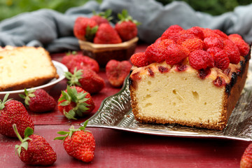 Cupcake with strawberries located on a table in the fresh air, on a metal tray
