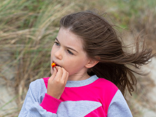 little cute girl eating rosehip