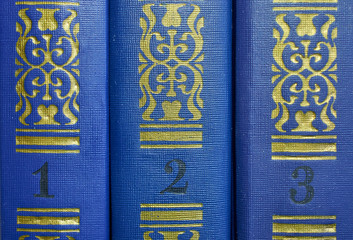 the pattern on covers of three volumes of old books close-up
