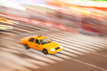 Fototapeta na wymiar Panning image of a Yellow Taxi cab in Times Square, New York City. New York. USA