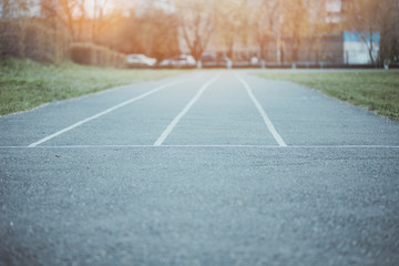 Obraz premium The road from asphalt with lines. The concept of choosing a path in business. All ways are free and without competition. Ahead of sunlight as success ahead of the way.
