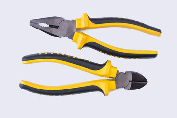 Obraz premium Pliers set with black and yellow handle. Repair tools on white background. Equipment for repair.