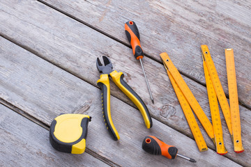 Construction tools on wooden background. Hand tools kit on wooden planks. Equipment for repairman.