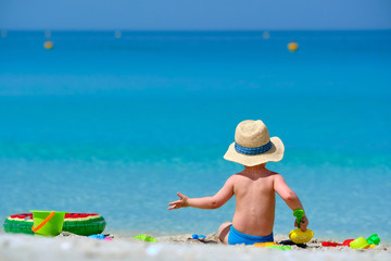 Two year old toddler playing on beach