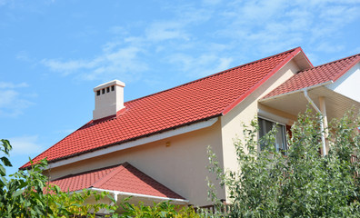 New house roofing construction with metal roof and waterproofing in problem roof areas exterior.