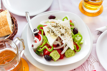 Greek salad with fresh vegetables, feta cheese and black olives