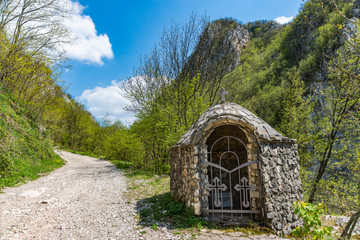 A small chapel of stone in Serbia. They contain small icons and texts of the God's Ten Commandments on Serbian. The text on photography is written on Serbian.