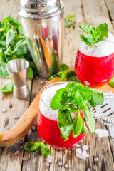 Summer sweet alcohol beverage.  Traditional Scandinavian cocktail with vodka  Akevitt; Akvavit. Fruit berry campary drink. Old rustic wooden background copy space