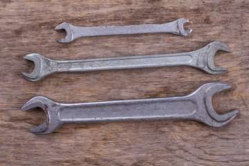 Wrenches on wooden background. Repair carpenter tools.