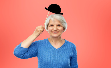 party props, photo booth and old people concept - portrait of smiling senior woman in blue sweater...