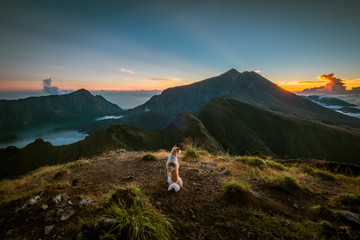 Naklejka premium Dog watching sunrise on Mount Rinjani, Lombok, Indonesia